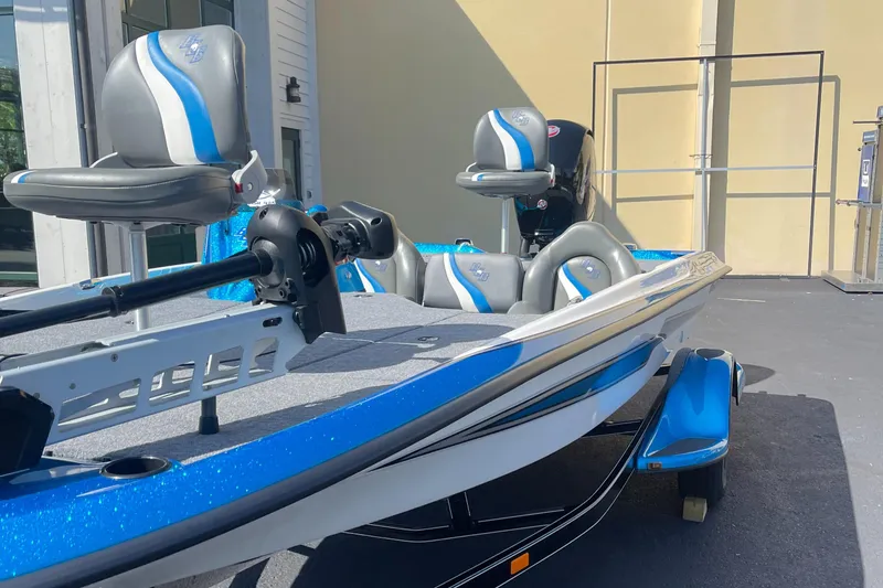Slide: The Image of 2024 Bass Cat Bobcat Vision fishing boat with blue and white accents. - 4