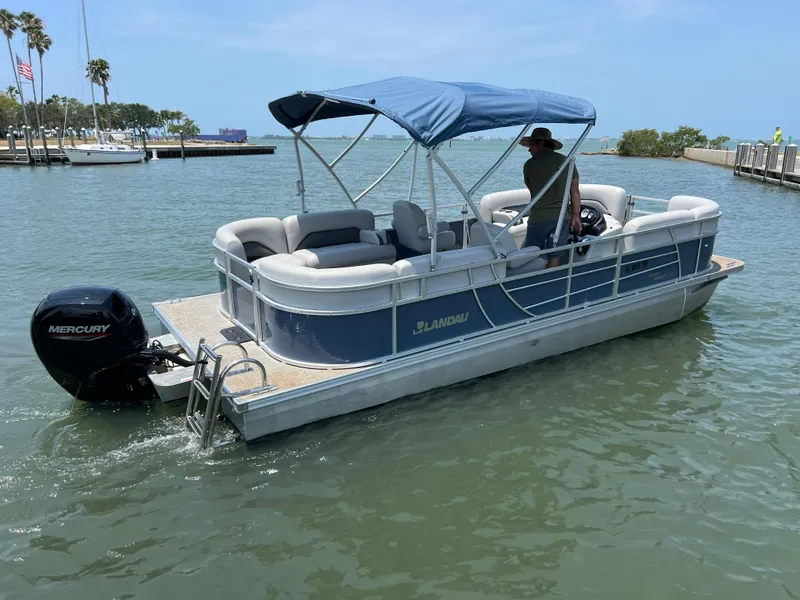 Slide: The Image of 2023 Landau Island Breeze 232 pontoon boat on the water with a Mercury outboard motor. - 14