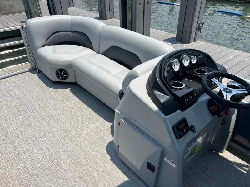 Slide: The Image of 2023 Landau Island Breeze 232 pontoon boat interior with plush seating and modern dashboard. - 5