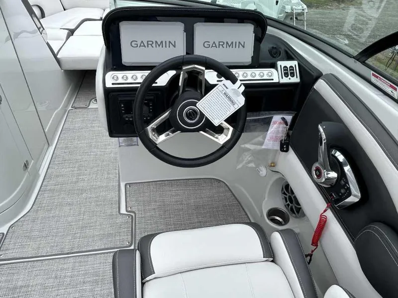 Slide: The Image of 2024 Crownline 270 XSS boat cockpit with Garmin navigation system and modern steering wheel. - 3