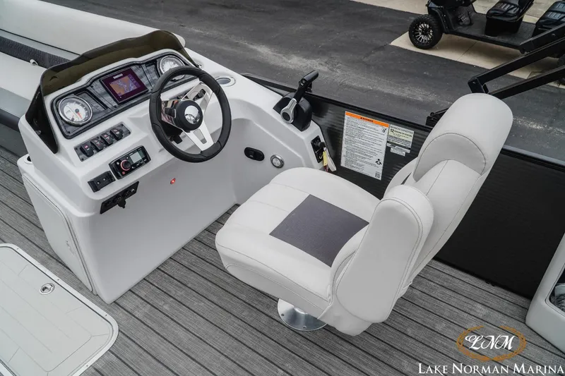 Slide: The Image of 2021 Godfrey SWEETWATER 2286 SFL boat cockpit with steering wheel and captain's chair. - 12
