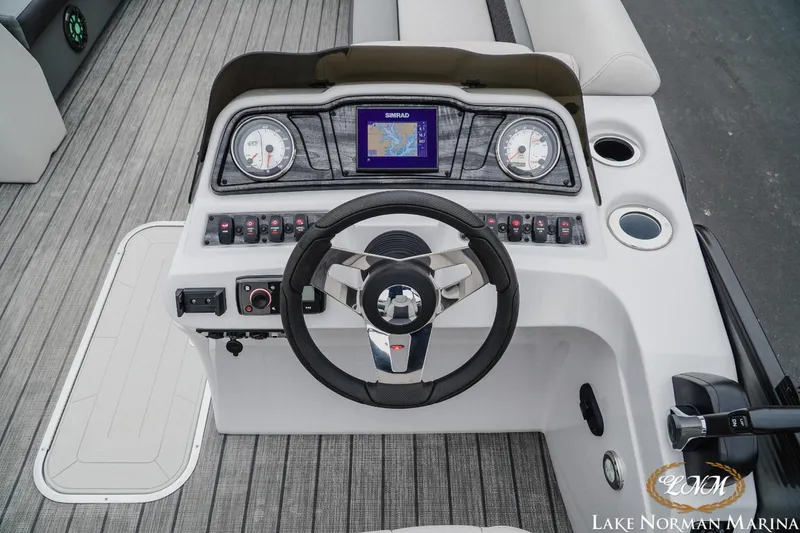 Slide: The Image of 2021 Godfrey SWEETWATER 2286 SFL boat dashboard with steering wheel and navigation system. - 13