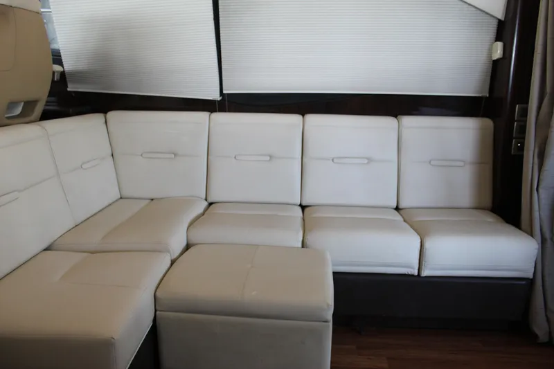 Slide: The Image of Interior seating of 2016 Sea Ray 400 Sundancer yacht with white leather upholstery. - 21