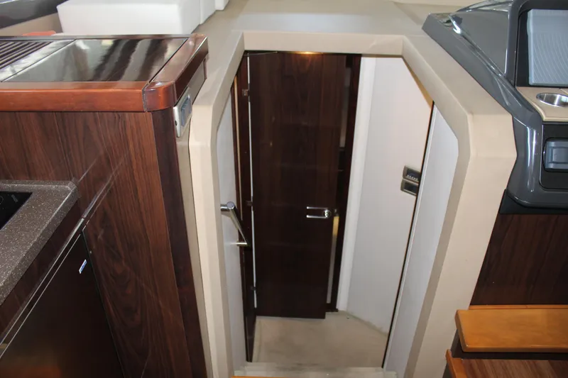 Slide: The Image of Interior of 2016 Sea Ray 400 Sundancer yacht, showing stairs and door to lower cabin. - 33