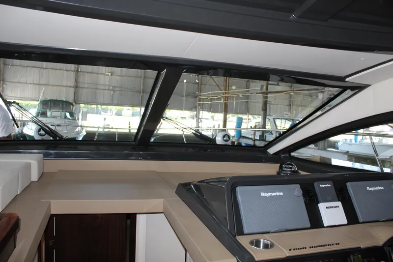 Slide: The Image of Interior helm of 2016 Sea Ray 400 Sundancer yacht with Raymarine navigation system. - 35