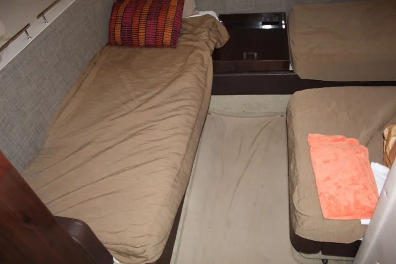 Slide: The Image of Interior cabin of 2016 Sea Ray 400 Sundancer with twin beds and beige bedding. - 40