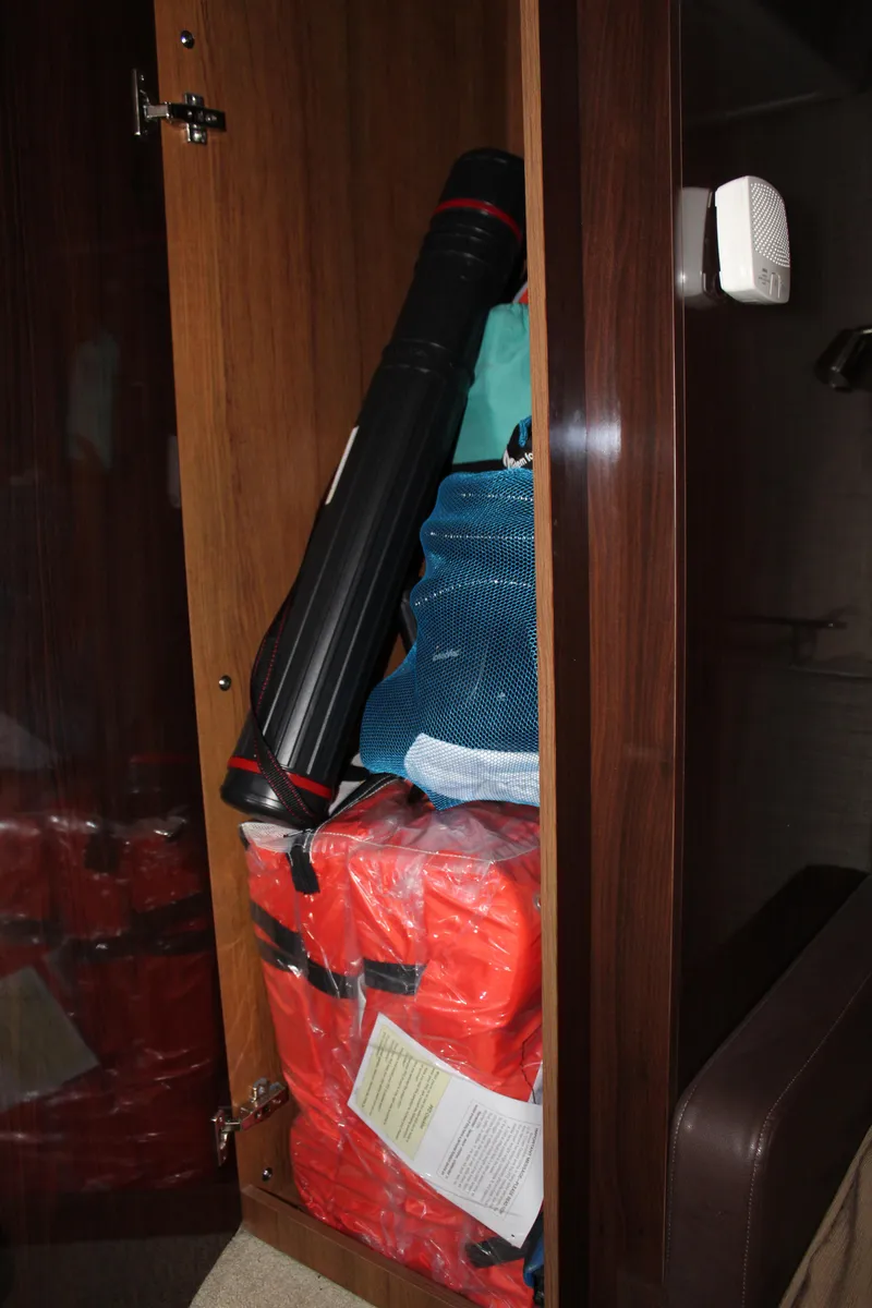 Slide: The Image of Storage compartment on 2016 Sea Ray 400 Sundancer with safety equipment. - 46