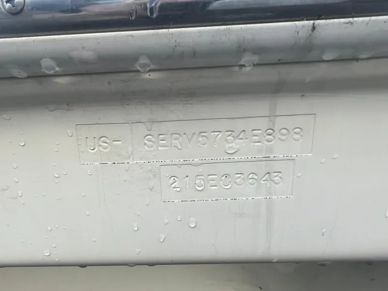 Slide: The Image of 1998 Sea Ray 210 Cuddy Cabin boat hull identification number with water droplets. - 11