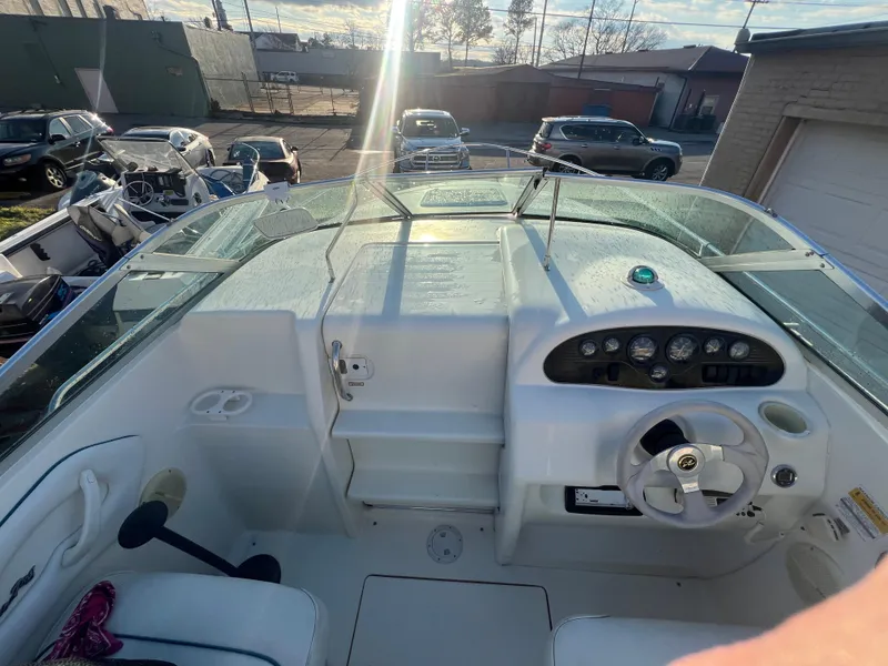 Slide: The Image of 1998 Sea Ray 210 Cuddy Cabin boat interior with steering wheel and dashboard controls. - 17