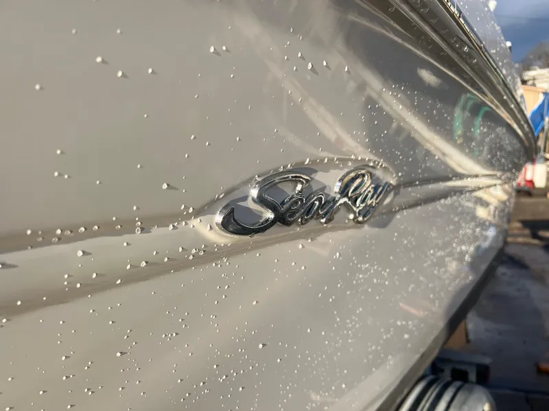 Slide: The Image of 1998 Sea Ray 210 Cuddy Cabin boat with water droplets on the hull. - 2