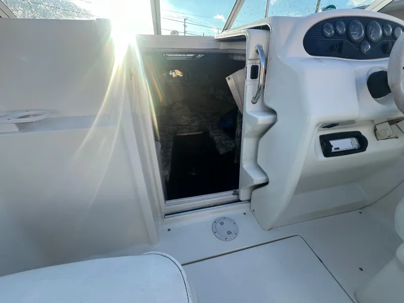 Slide: The Image of 1998 Sea Ray 210 Cuddy Cabin interior with sunlight streaming through the cabin door. - 22