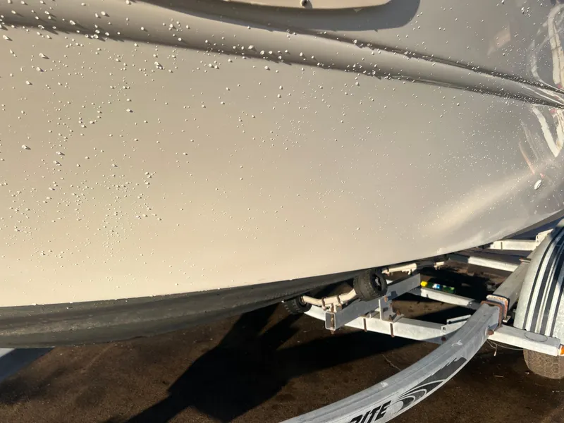 Slide: The Image of 1998 Sea Ray 210 Cuddy Cabin boat hull on trailer, close-up view. - 6