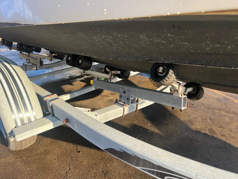 Slide: The Image of Trailer supporting a 1998 Sea Ray 210 Cuddy Cabin boat on a sunny day. - 7