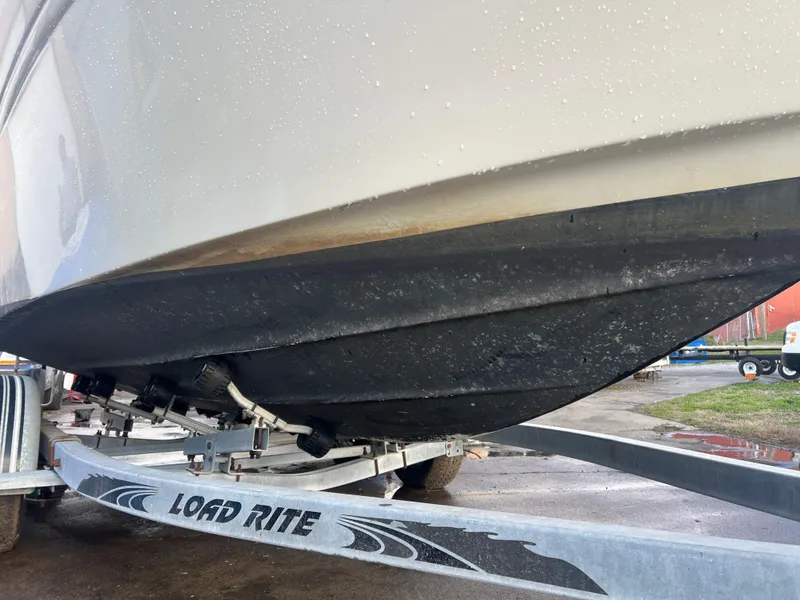 Slide: The Image of 1998 Sea Ray 210 Cuddy Cabin boat on Load Rite trailer, close-up of hull. - 9