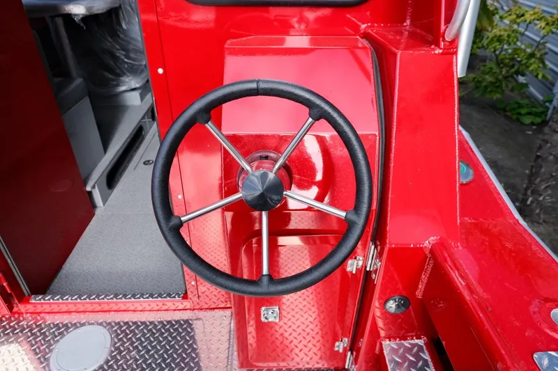 Slide: The Image of Red 2024 Hewescraft 270 Alaskan boat steering wheel and console. - 10