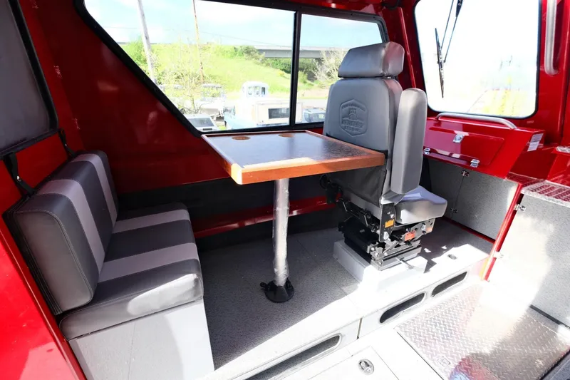 Slide: The Image of 2024 Hewescraft 270 Alaskan interior with seating and table, red and gray design. - 12
