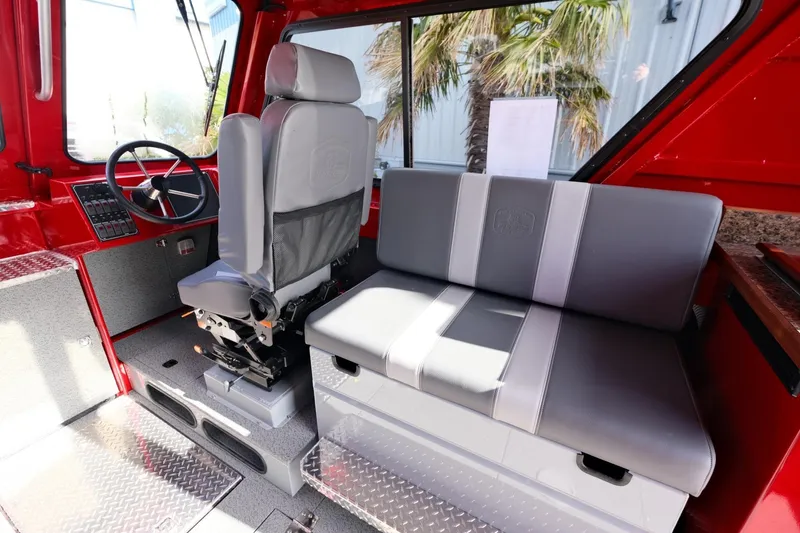 Slide: The Image of Interior of 2024 Hewescraft 270 Alaskan boat with red and gray seating. - 13