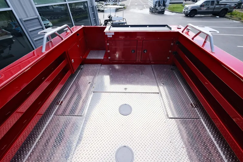 Slide: The Image of 2024 Hewescraft 270 Alaskan boat deck with red sides and diamond plate flooring. - 9