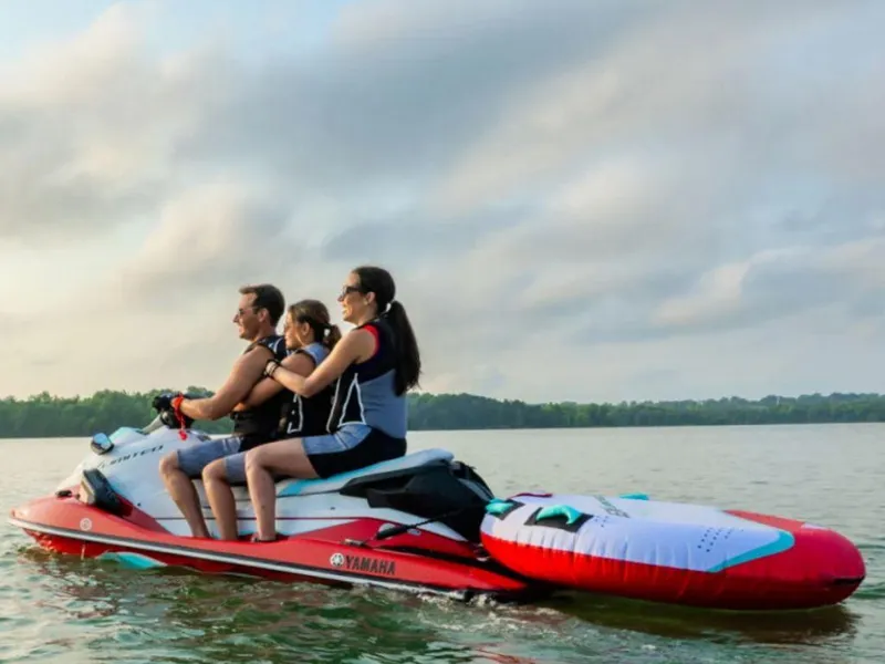 Slide: The Image of 2024 Yamaha WaveRunner EX® Limited on a lake with three riders enjoying the water. - 4