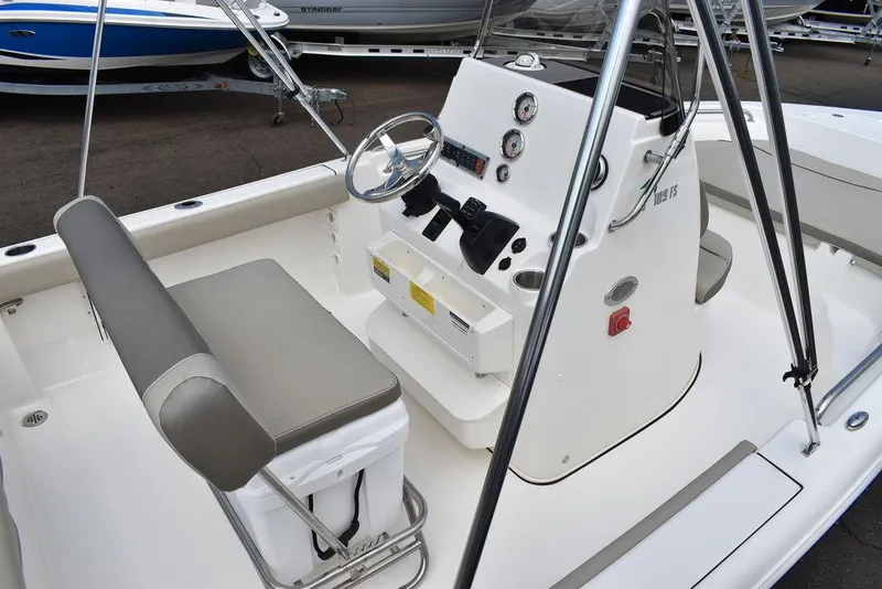 Slide: The Image of 2024 Key West 189 FS boat interior with steering console and seating. - 10