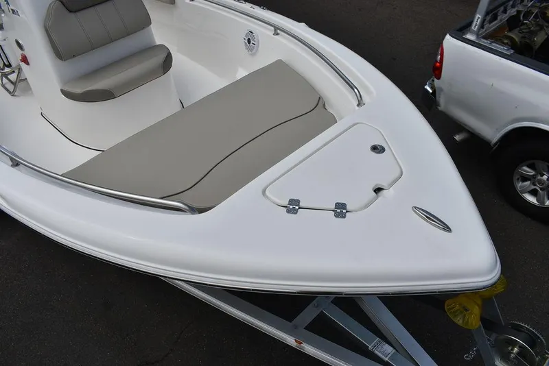 Slide: The Image of 2024 Key West 189 FS boat with cushioned seating and storage compartment. - 12