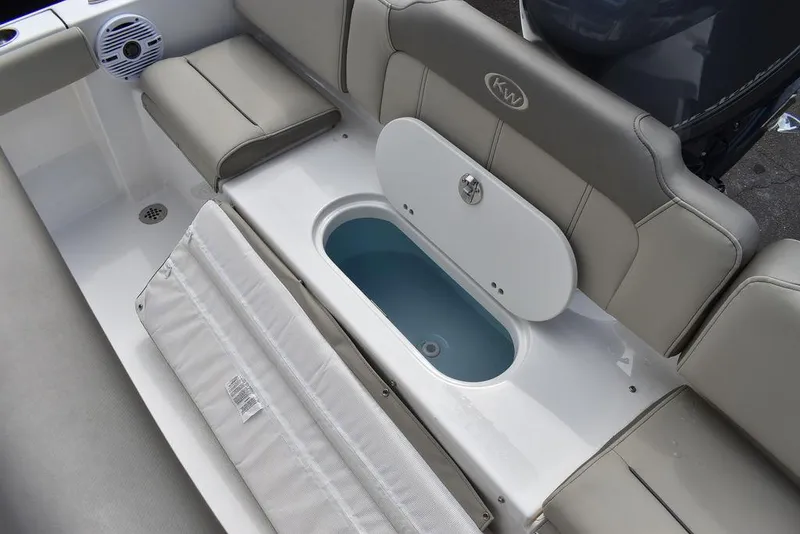 Slide: The Image of 2024 Key West 189 FS boat seating area with storage compartment. - 17