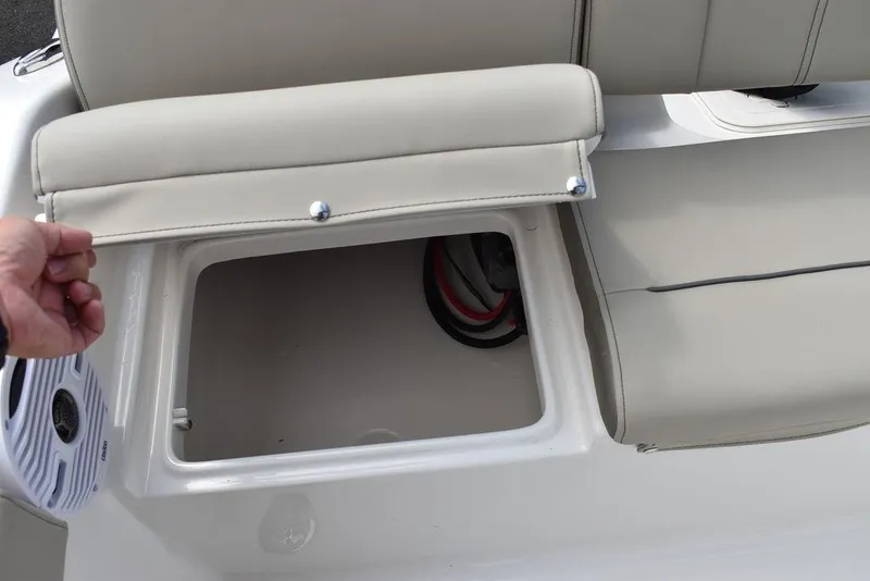 Slide: The Image of 2024 Key West 189 FS boat seat storage compartment with open lid. - 20