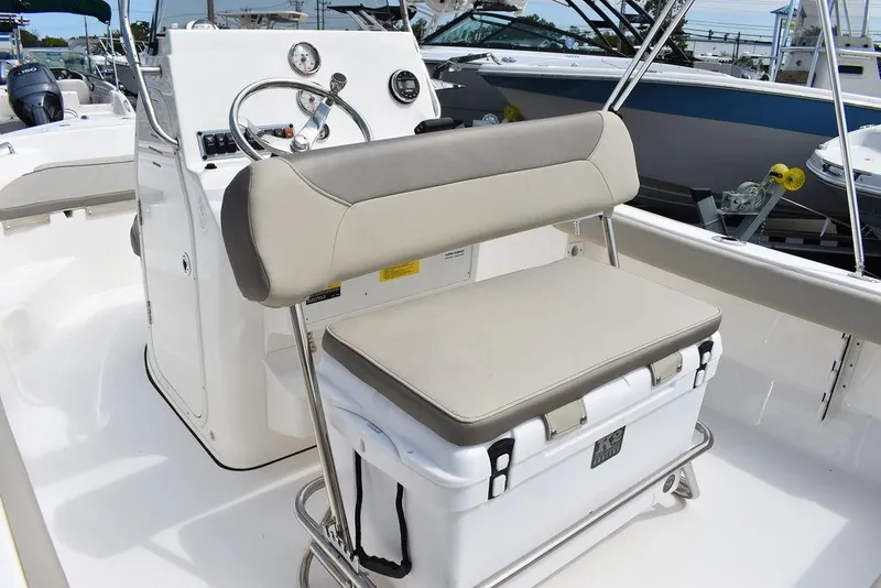 Slide: The Image of 2024 Key West 189 FS boat interior with cushioned seating and steering console. - 23