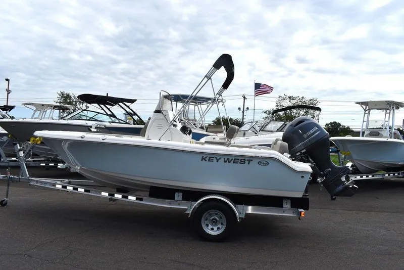 Slide: The Image of 2024 Key West 189 FS boat on trailer, parked outdoors under cloudy sky. - 3