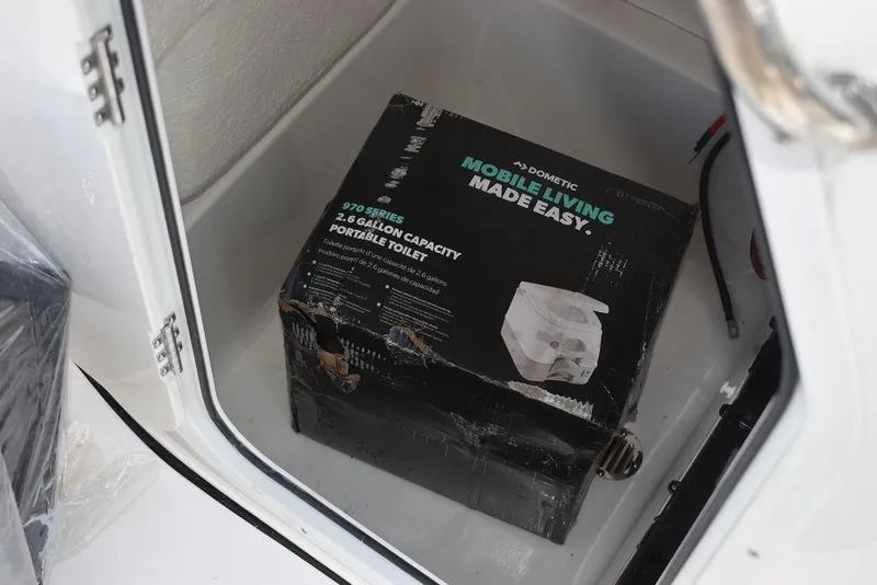 Slide: The Image of Portable toilet box inside 2024 Key West 189 FS boat storage compartment. - 37