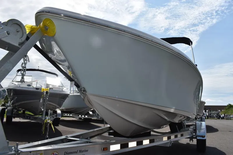 Slide: The Image of 2024 Key West 189 FS boat on trailer under a cloudy sky. - 46