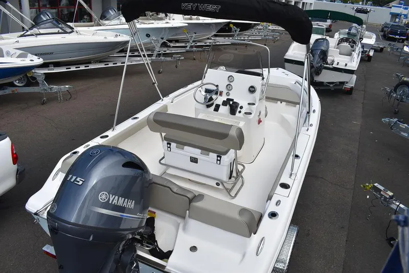 Slide: The Image of 2024 Key West 189 FS boat with Yamaha 115 engine, docked in a marina. - 8