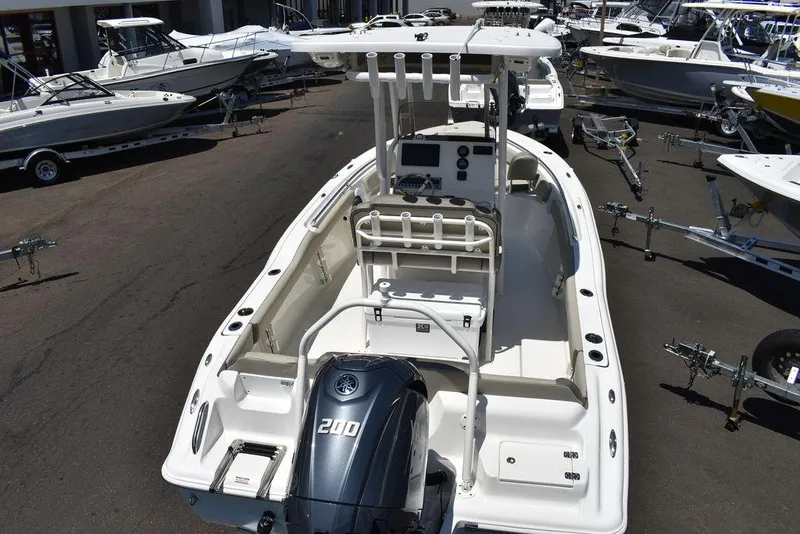 Slide: The Image of 2024 Key West 219 FS boat with Yamaha 200 engine, docked among other boats. - 10