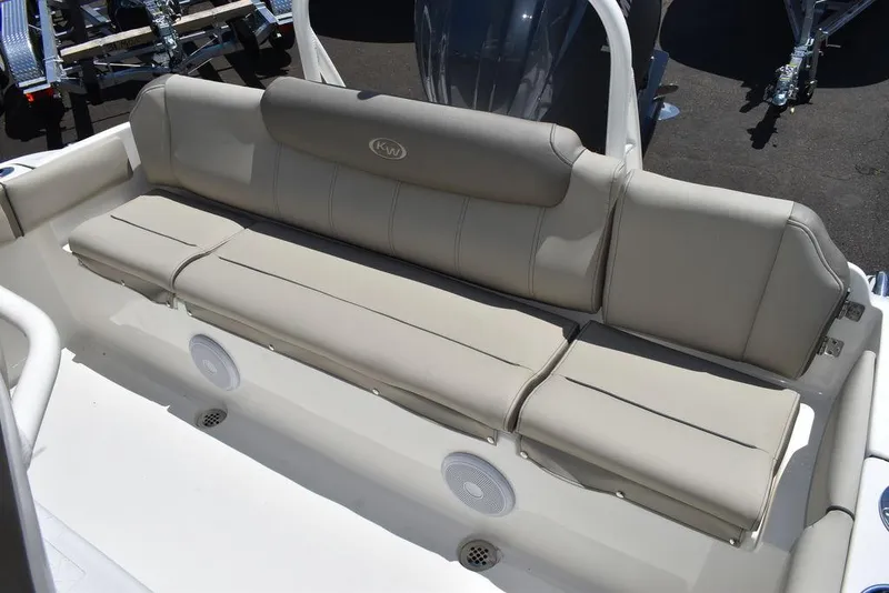Slide: The Image of 2024 Key West 219 FS boat with beige cushioned seating and built-in speakers. - 25