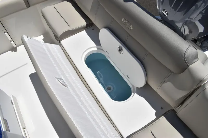 Slide: The Image of 2024 Key West 219 FS boat with open storage compartment and cushioned seating. - 26