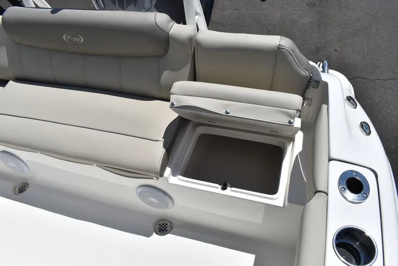 Slide: The Image of 2024 Key West 219 FS boat with open storage compartment and cushioned seating. - 28