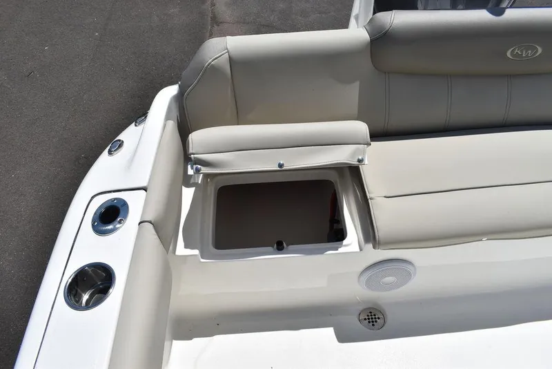 Slide: The Image of 2024 Key West 219 FS boat with open storage compartment and cushioned seating. - 29