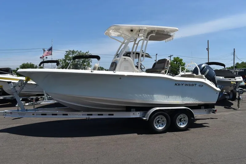 Slide: The Image of 2024 Key West 219 FS boat on a trailer in a parking lot. - 4