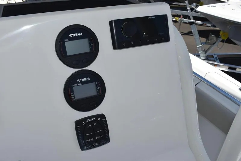 Slide: The Image of 2024 Key West 219 FS boat dashboard with Yamaha gauges and Fusion audio system. - 40