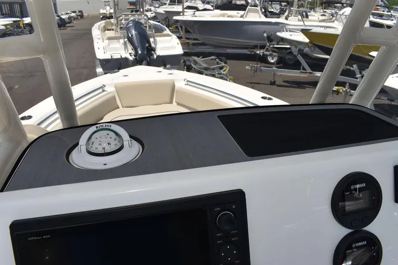 Slide: The Image of 2024 Key West 219 FS boat dashboard with compass and navigation controls. - 42