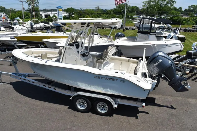 Slide: The Image of 2024 Key West 219 FS boat on trailer, side view, in a marina. - 6