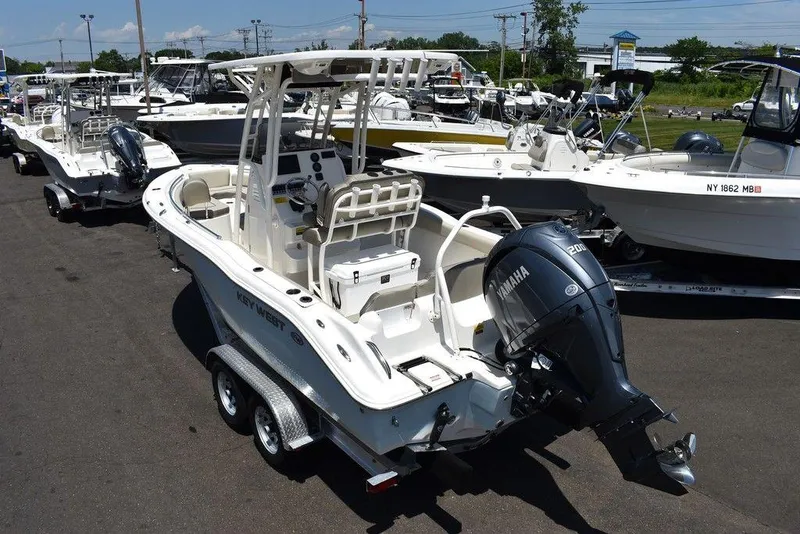 Slide: The Image of 2024 Key West 219 FS boat with Yamaha outboard motor on trailer. - 7