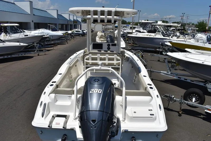 Slide: The Image of 2024 Key West 219 FS boat with 200 HP engine in a dealership lot. - 9