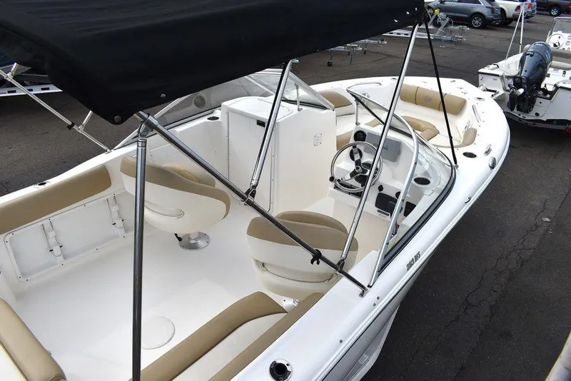 Slide: The Image of 2018 Key West 203DFS boat with beige seating and black canopy. - 11