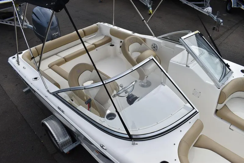 Slide: The Image of 2018 Key West 203DFS boat with beige seating and windshield. - 12