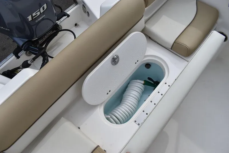 Slide: The Image of 2018 Key West 203DFS boat with open storage compartment and Yamaha 150 engine. - 23