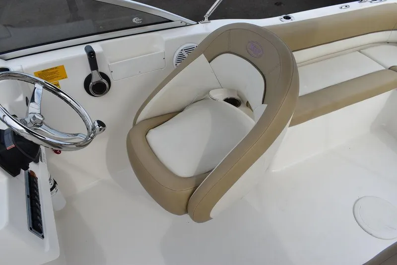 Slide: The Image of 2018 Key West 203DFS boat interior with steering wheel and cushioned seating. - 28