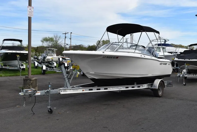 Slide: The Image of 2018 Key West 203DFS boat on a trailer in a parking lot. - 3