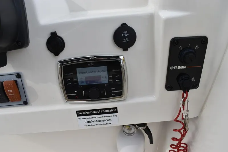 Slide: The Image of 2018 Key West 203DFS boat dashboard with Polk audio system and Yamaha controls. - 31