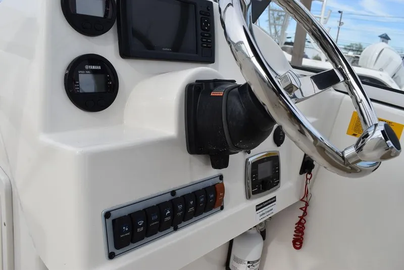 Slide: The Image of 2018 Key West 203DFS boat dashboard with steering wheel and control panel. - 33